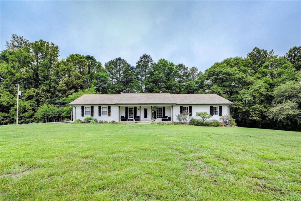 a front view of a house with a garden