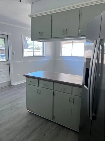 a kitchen with cabinets and wooden floors