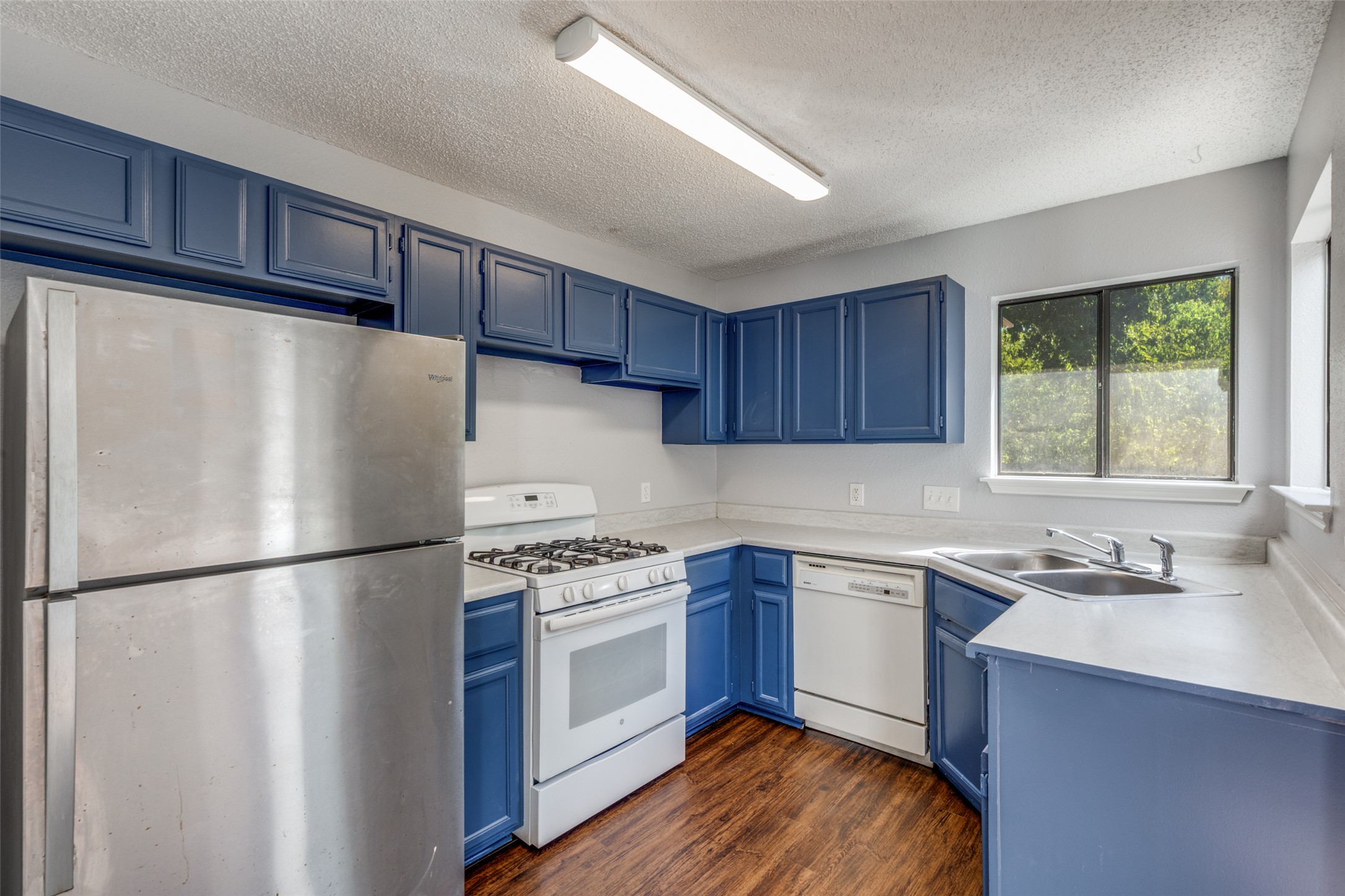 12323 Little Emily Way Austin, TX 78753 - Photo 11 of 24 a kitchen with stainless steel appliances a refrigerator sink and cabinets