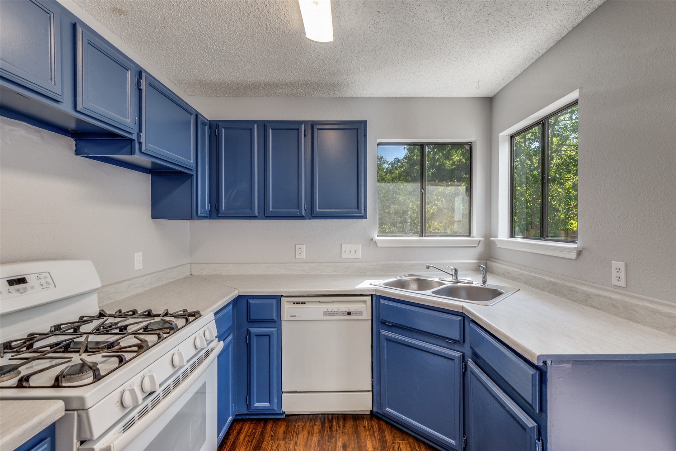 12323 Little Emily Way Austin, TX 78753 - Photo 12 of 24 a kitchen with a sink stove top oven and cabinets