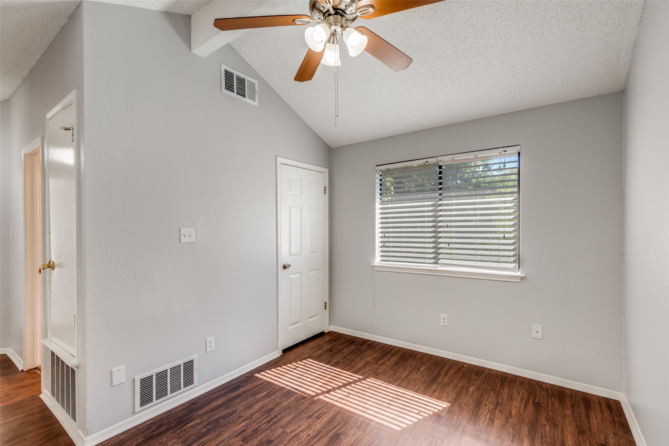 12323 Little Emily Way Austin, TX 78753 - Photo 17 of 24 a view of an empty room with window and wooden floor