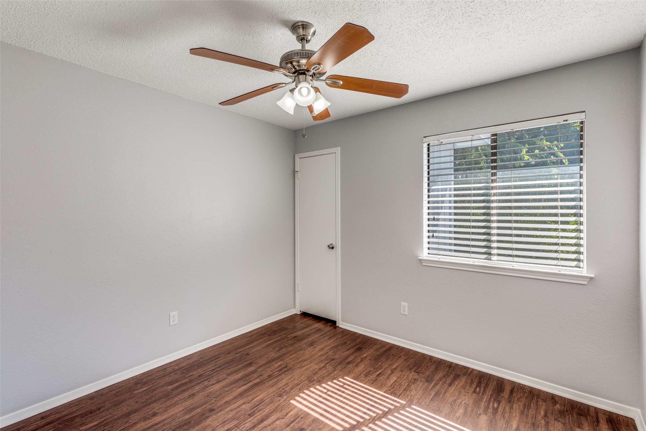 12323 Little Emily Way Austin, TX 78753 - Photo 19 of 24 a view of an empty room with wooden floor and a window