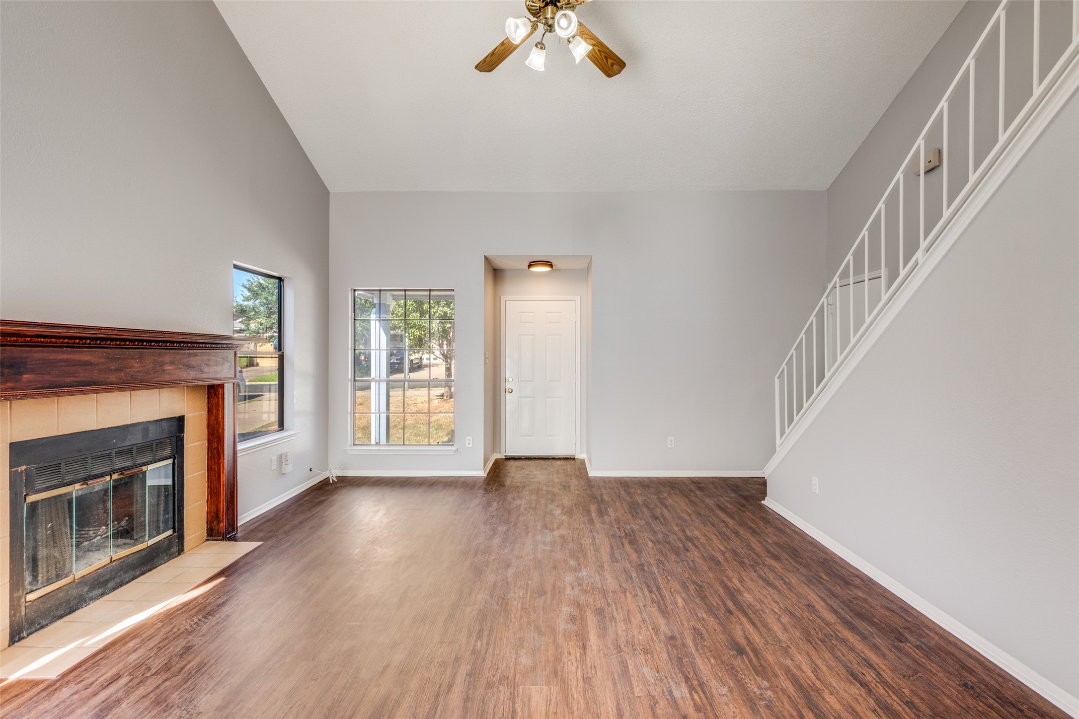 12323 Little Emily Way Austin, TX 78753 - Photo 3 of 24 a view of an empty room with wooden floor fireplace and a window