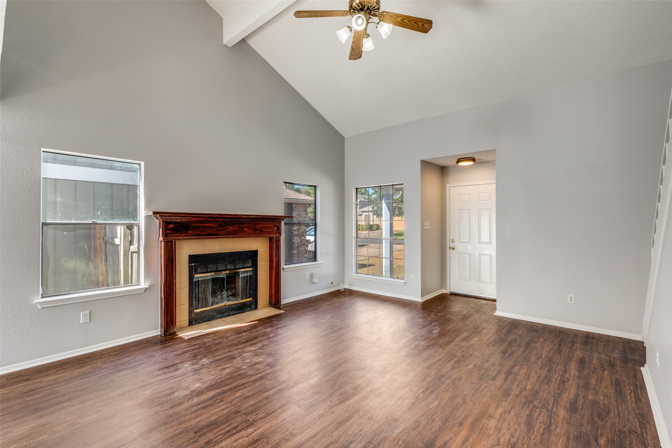 12323 Little Emily Way Austin, TX 78753 - Photo 4 of 24 an empty room with wooden floor fireplace and windows