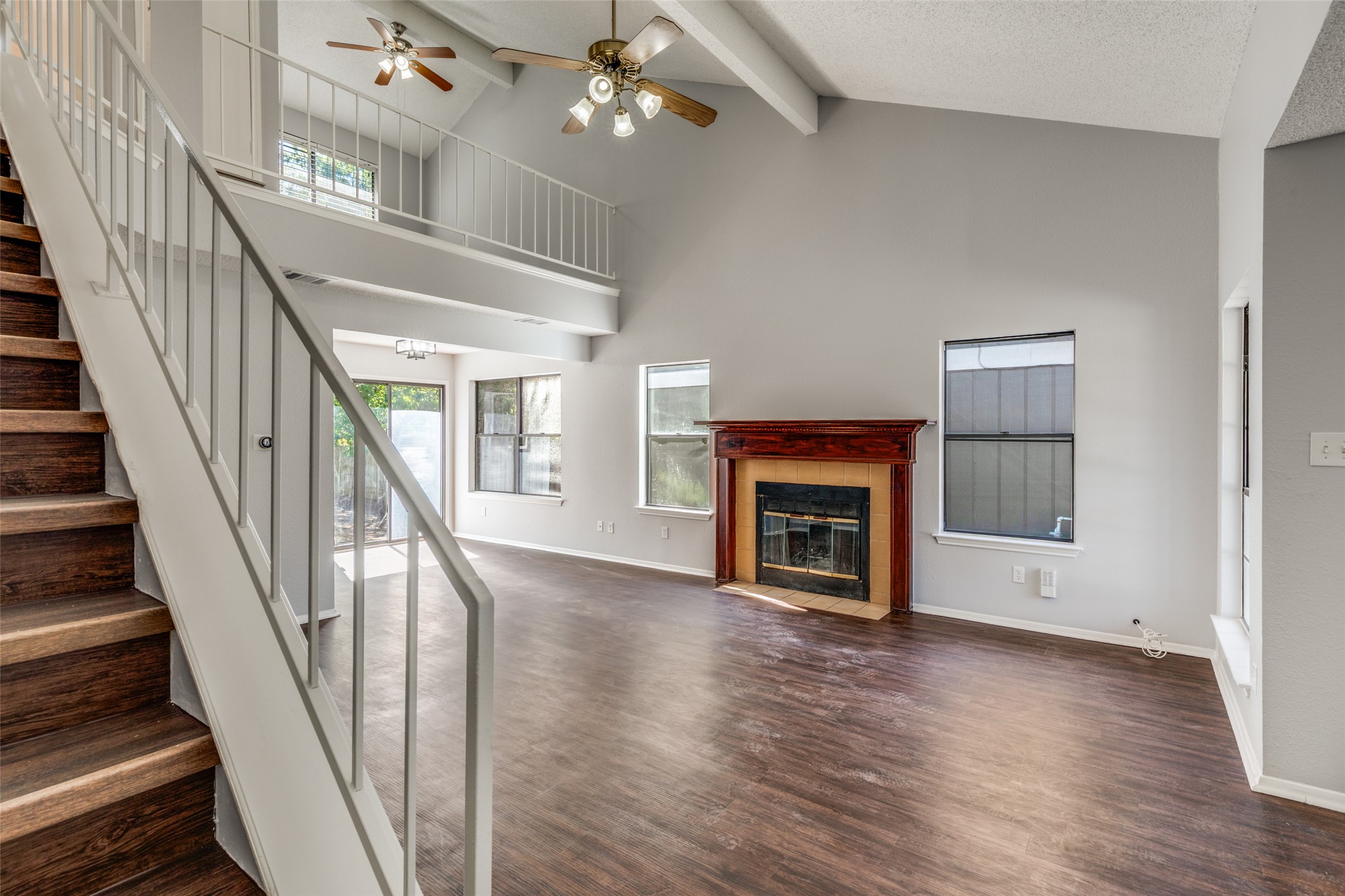 12323 Little Emily Way Austin, TX 78753 - Photo 5 of 24 a view of an empty room with wooden floor fireplace and a window
