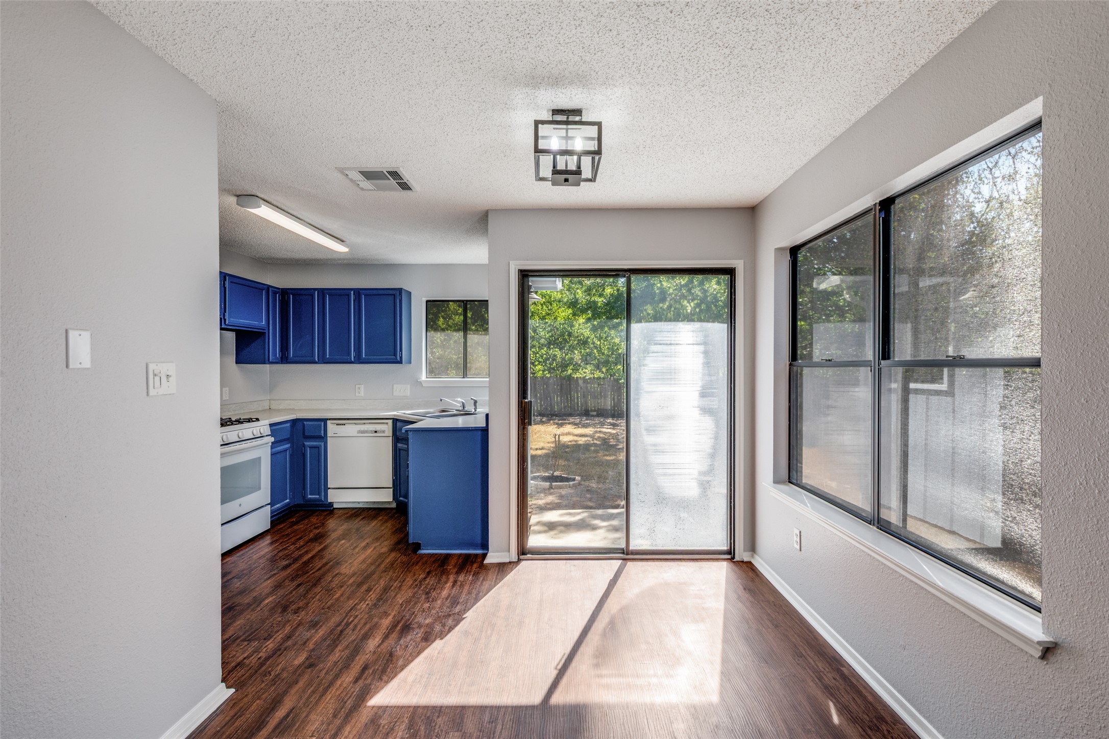 12323 Little Emily Way Austin, TX 78753 - Photo 8 of 24 a kitchen with stainless steel appliances wooden cabinets and a stove top oven