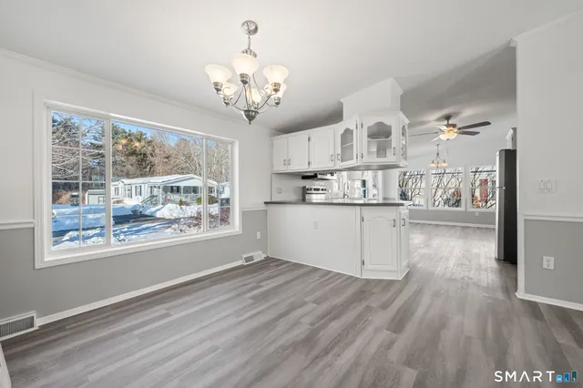 a view of a livingroom with a ceiling fan and window