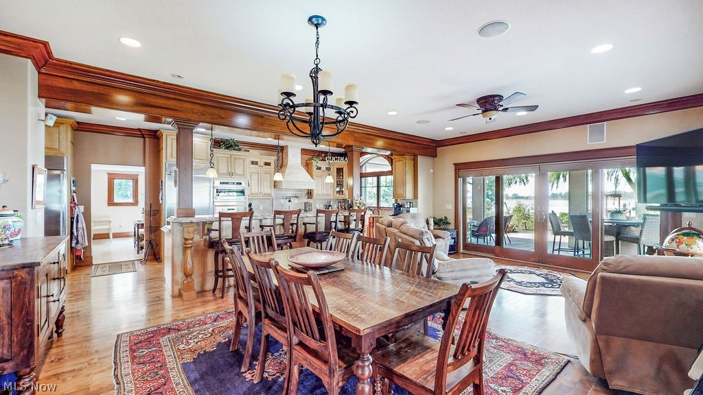 1431 Cedar Point Road Sandusky, OH 44870 - Photo 17 of 50 Dining space with ornamental molding, a ceiling fan, a chandelier, recessed lighting, and light wood-style flooring