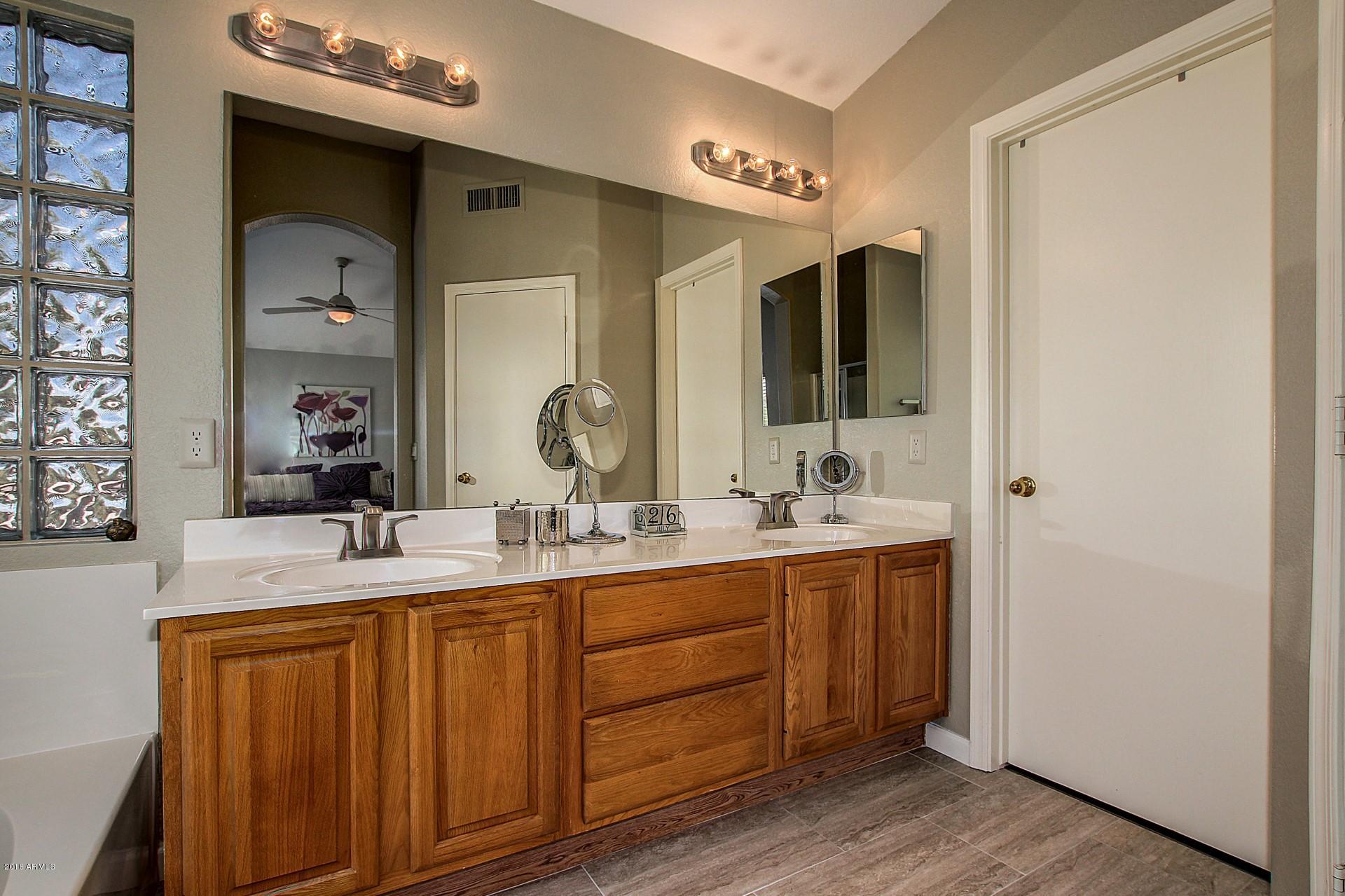 462 West Colt Road Tempe, AZ 85284 - Photo 17 of 29 a bathroom with a double vanity sink and a mirror