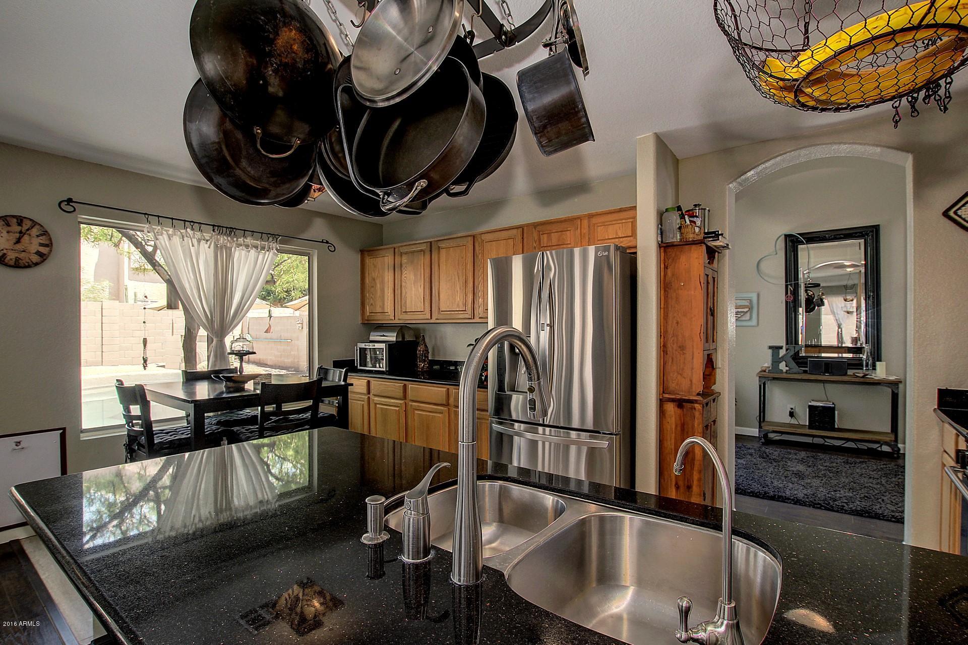 462 West Colt Road Tempe, AZ 85284 - Photo 6 of 29 a kitchen with stainless steel appliances granite countertop a sink a stove and refrigerator