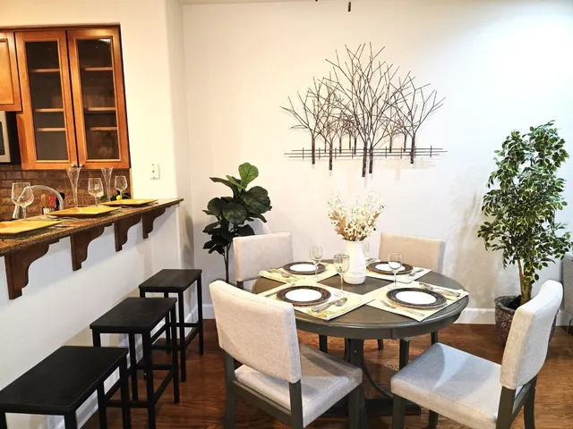 a room with furniture a rug and a potted plant