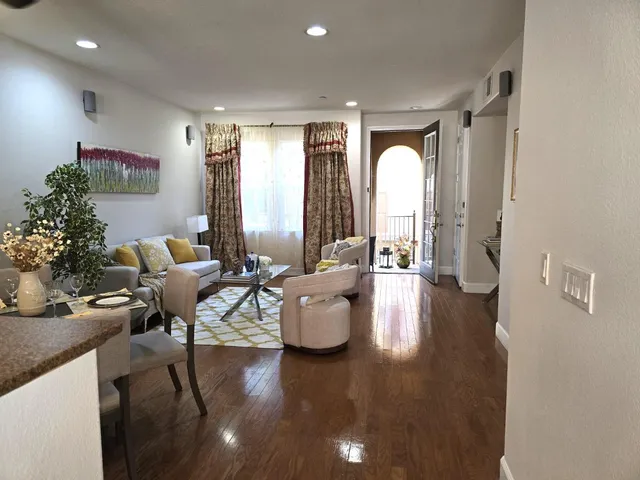 a kitchen with stainless steel appliances granite countertop a refrigerator a stove and a sink