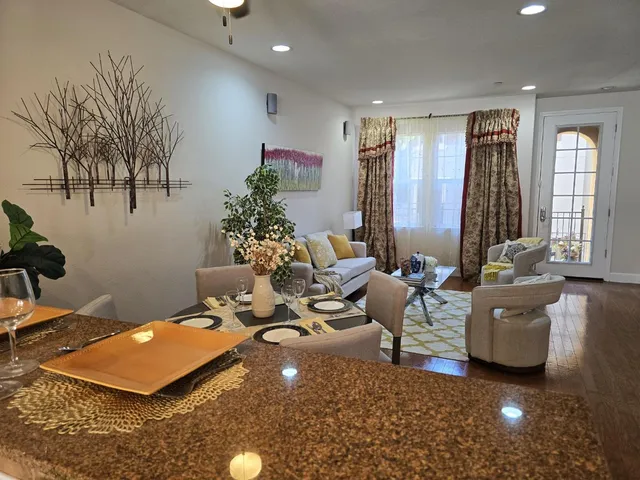 a view of kitchen with stainless steel appliances granite countertop a stove and a sink