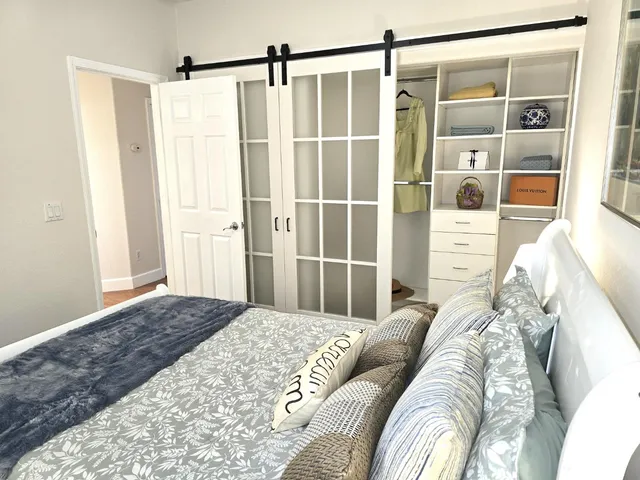 a bedroom with a bed and a window