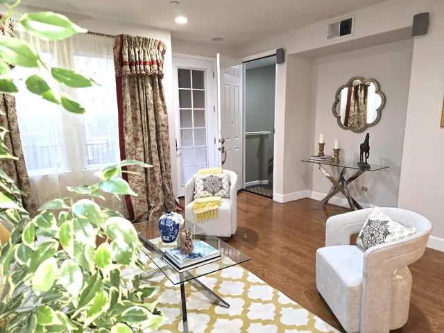a living room with furniture and a wooden floor