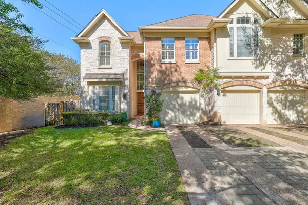 a view of a front of a house with a yard