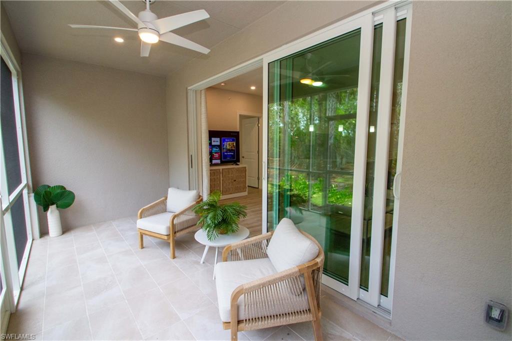 268 Indies Drive East, Unit 102 Naples, FL 34114 - Photo 14 of 48 a living room with furniture and potted plant