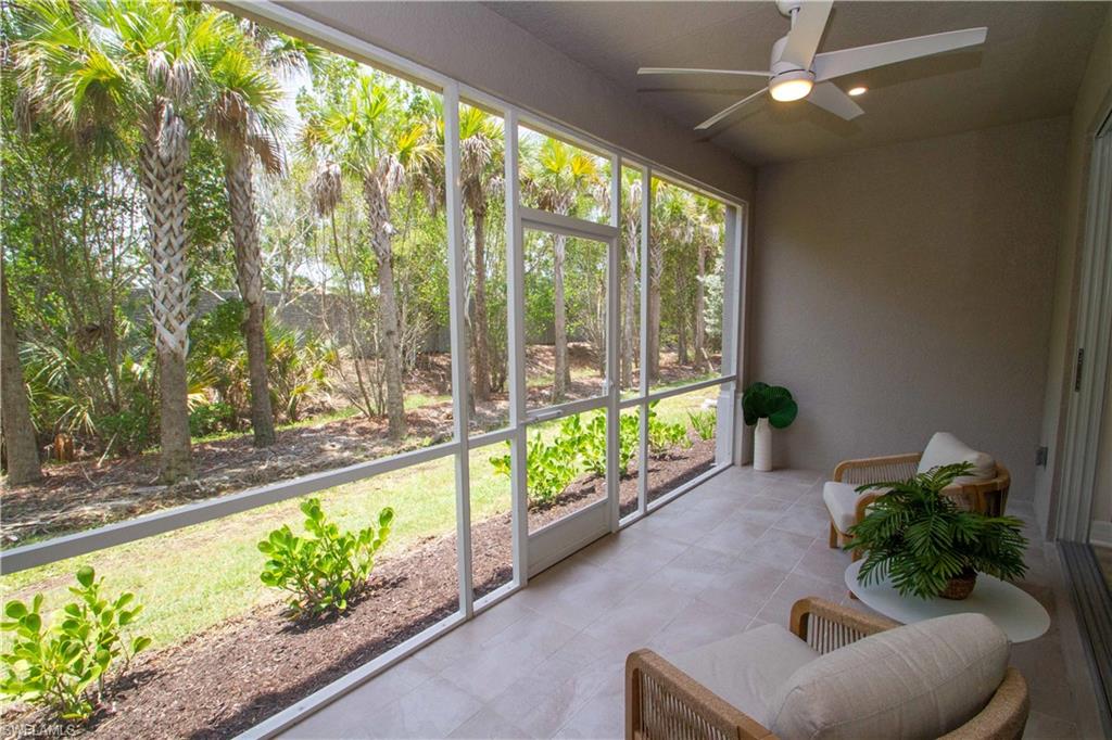 268 Indies Drive East, Unit 102 Naples, FL 34114 - Photo 15 of 48 a living room with furniture and a large window