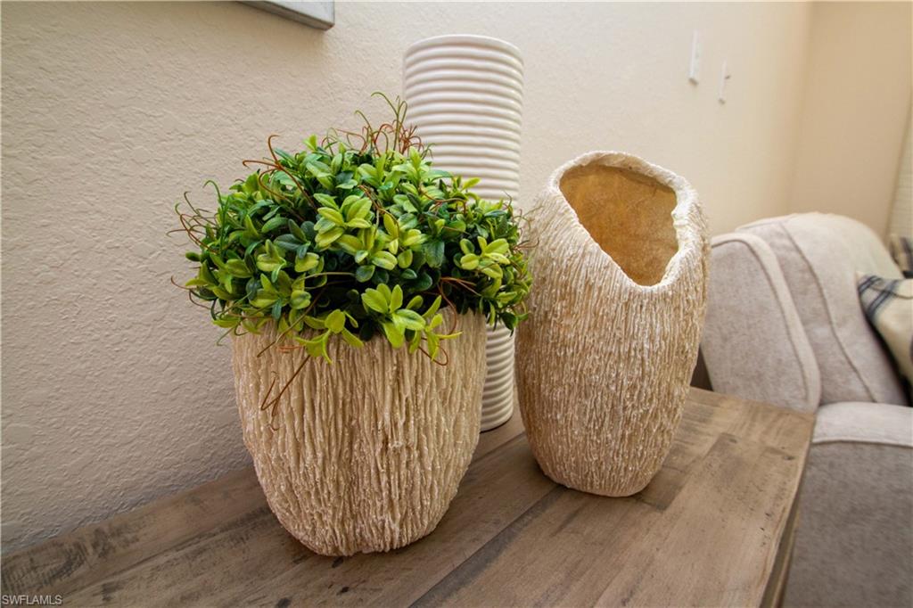 268 Indies Drive East, Unit 102 Naples, FL 34114 - Photo 18 of 48 a vase of flowers sitting on a table