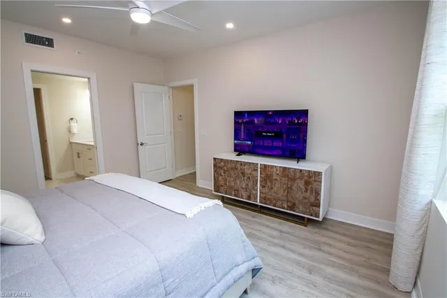 a bedroom with a bed and a painting on the wall