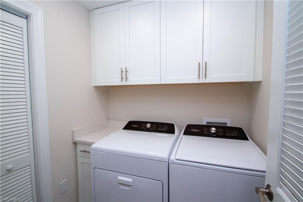 268 Indies Drive East, Unit 102 Naples, FL 34114 - Photo 35 of 48 a utility room with dryer and washer
