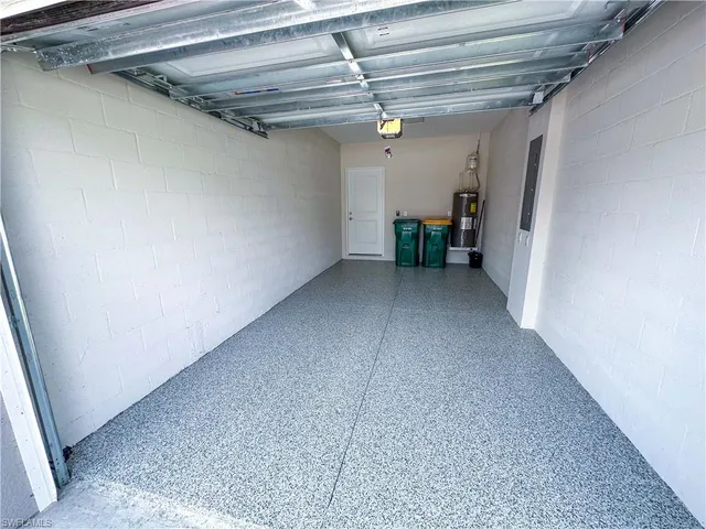 a dining room with furniture potted plants and wooden floor