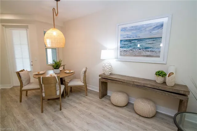 a dining room with furniture and wooden floor