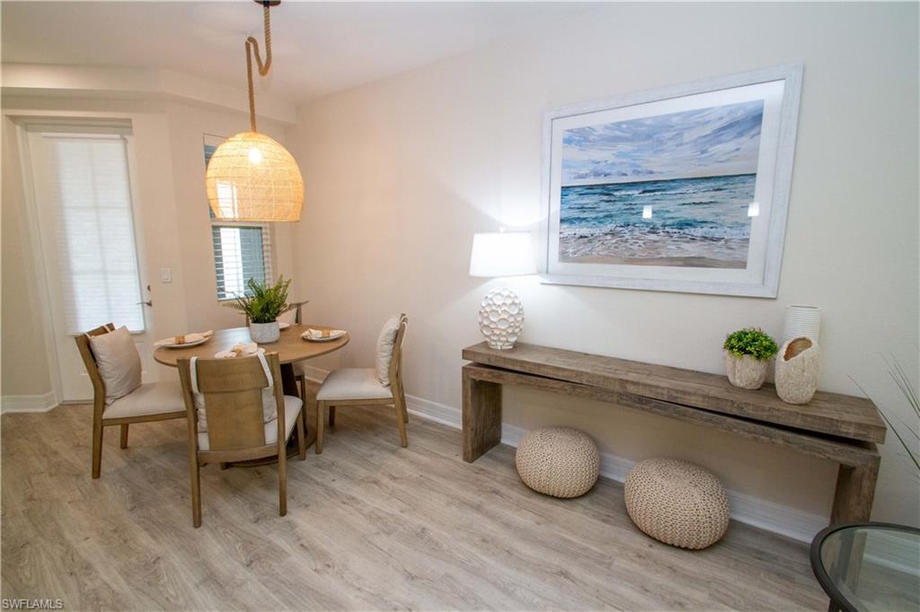 268 Indies Drive East, Unit 102 Naples, FL 34114 - Photo 5 of 48 a dining room with furniture and wooden floor