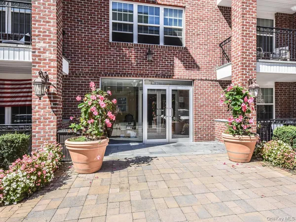 a view of a house with patio and flowers