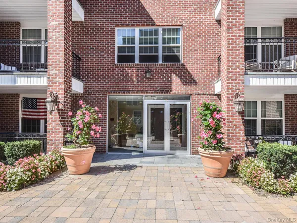 a view of a house with outdoor space and potted plants