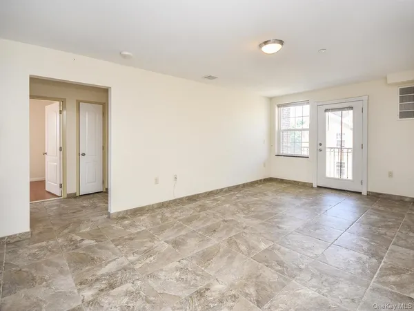 an empty room with windows and closet