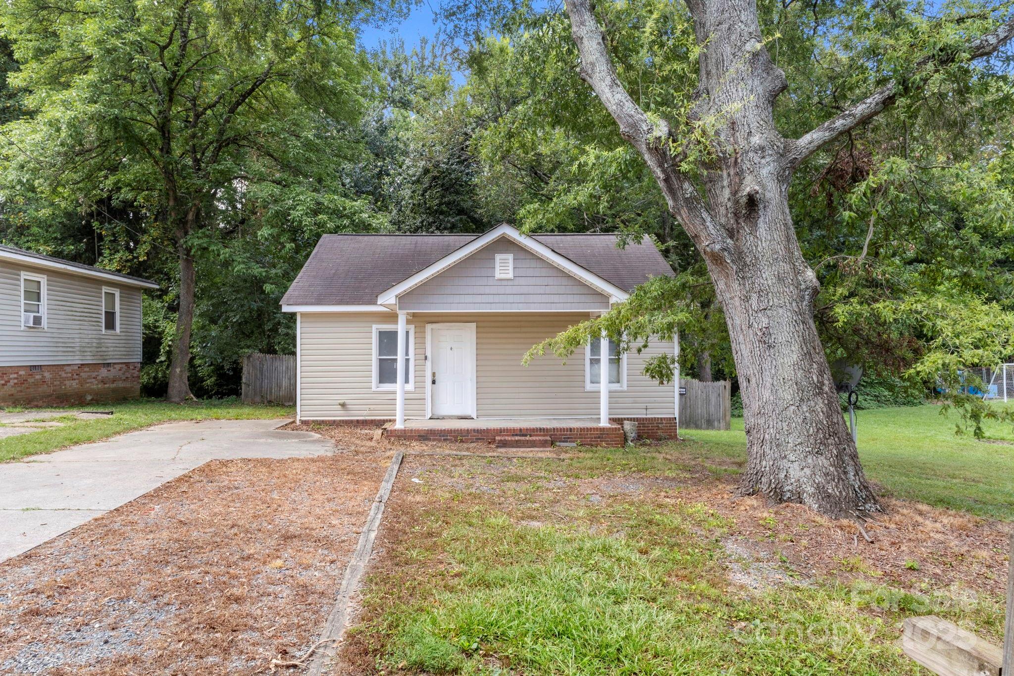4034 Rutgers Avenue Charlotte, NC 28206 - Photo 2 of 6 a front view of a house with a garden and yard