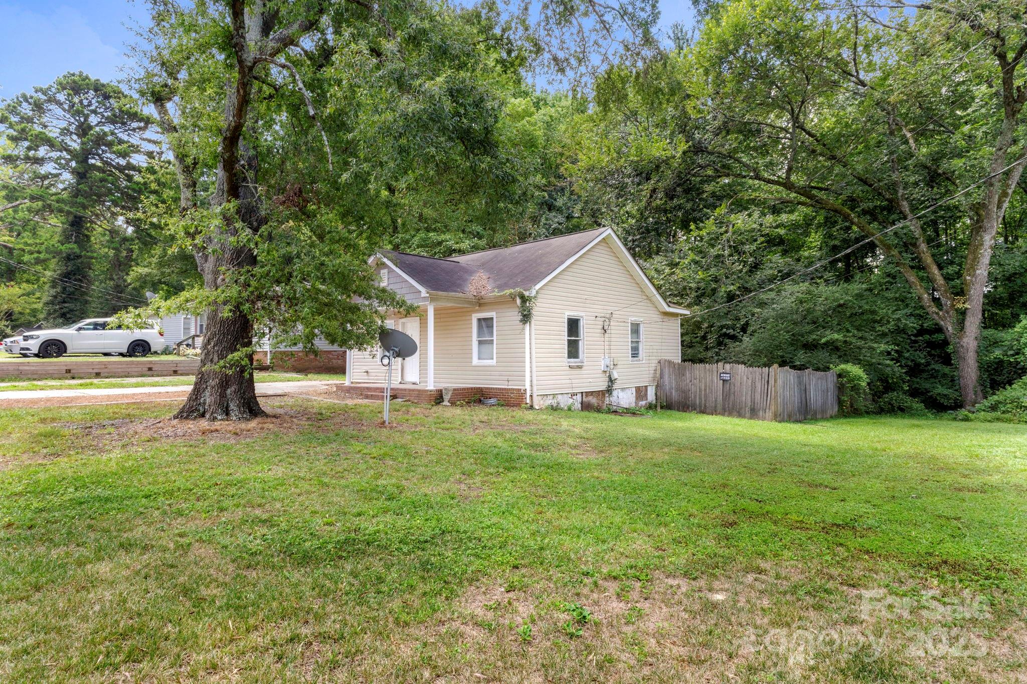 4034 Rutgers Avenue Charlotte, NC 28206 - Photo 3 of 6 a view of a house with backyard and trees