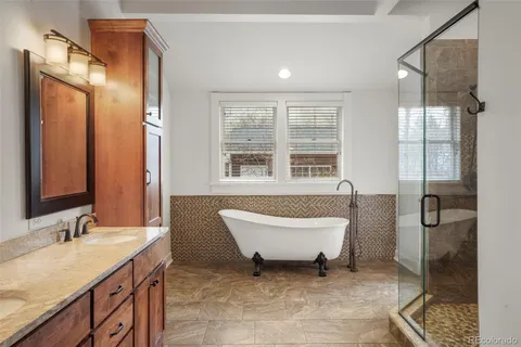 a view of a wooden deck with a barbeque grill and wooden fence