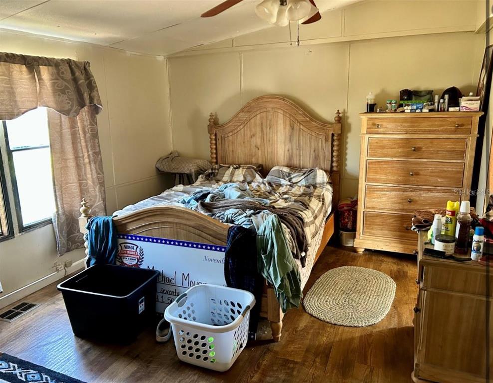 11475 167th Road Live Oak, FL 32060 - Photo 13 of 15 a bedroom with a bed and a mirror