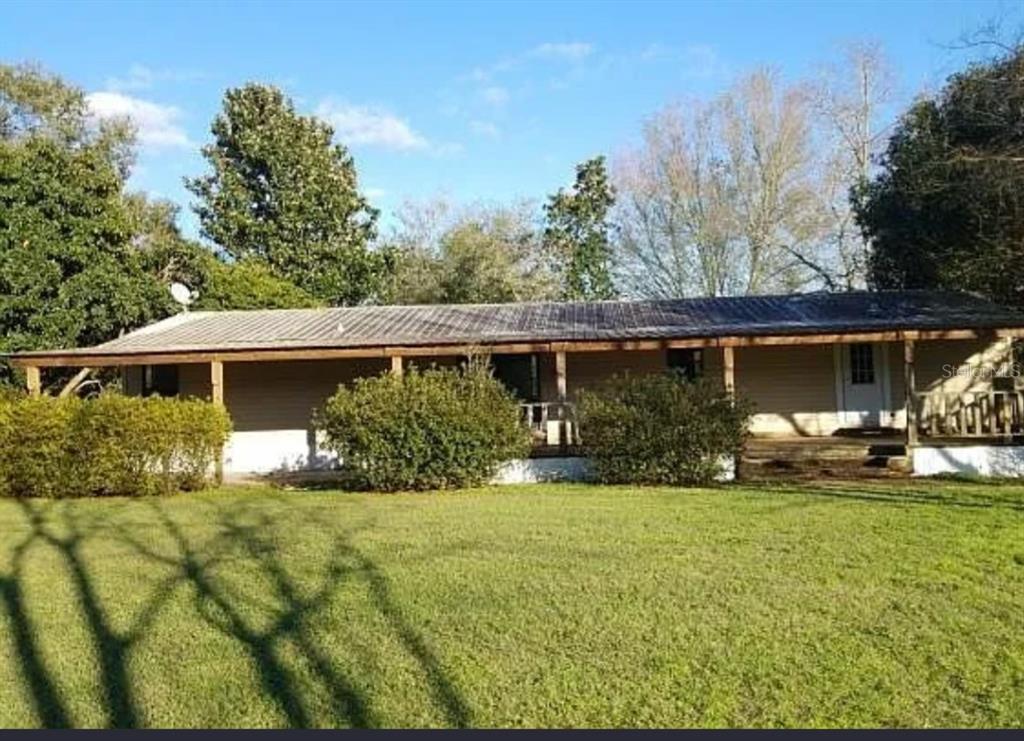 11475 167th Road Live Oak, FL 32060 - Photo 2 of 15 a view of a house with a yard