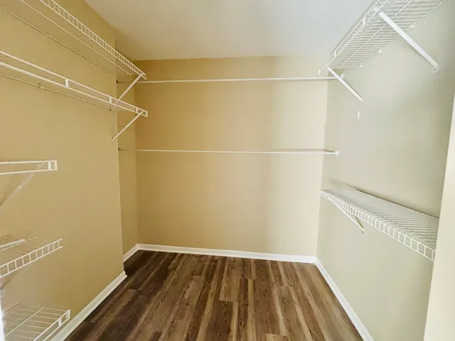 a view of a room with wooden floor