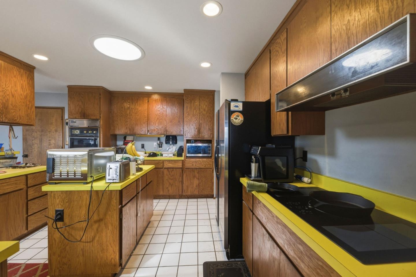 917 Holly Road Belmont, CA 94002 - Photo 27 of 82 a kitchen with stainless steel appliances granite countertop a sink a stove and a refrigerator