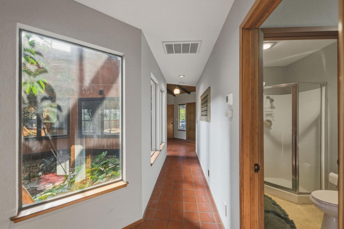 917 Holly Road Belmont, CA 94002 - Photo 57 of 82 a view of a hallway with wooden floor and glass door