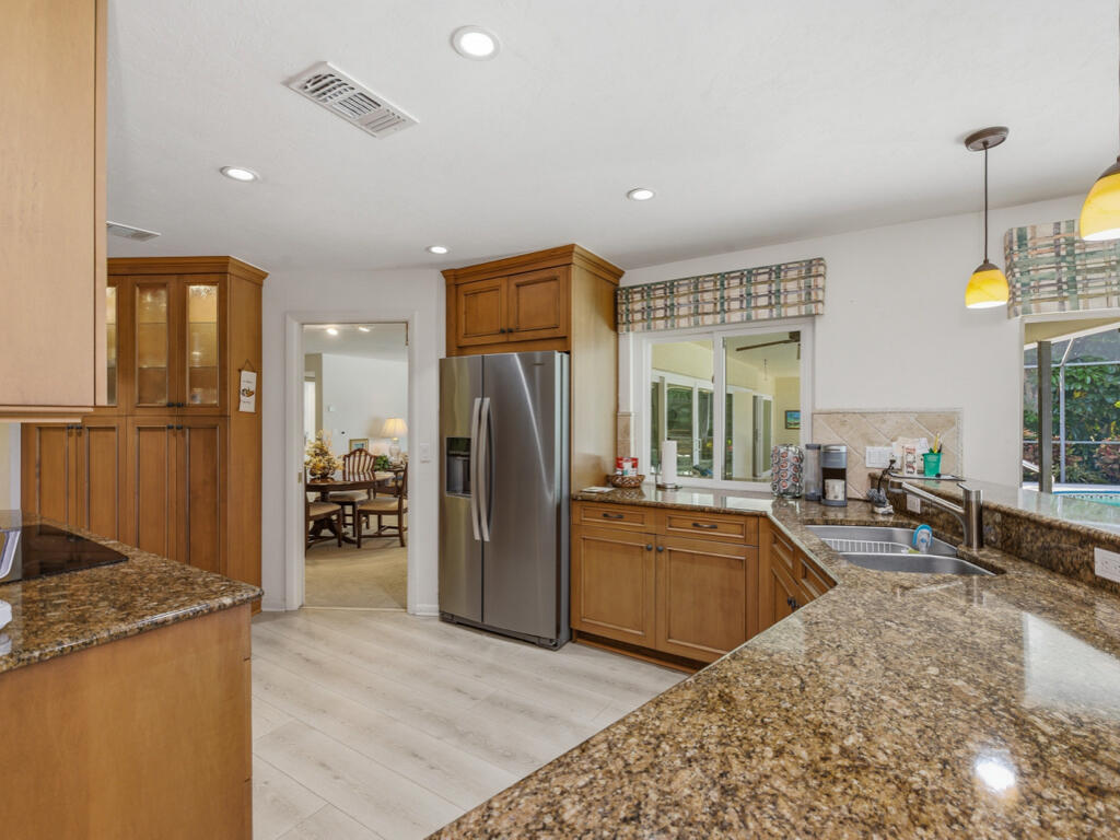 314 Torrey Pines Point Naples, FL 34113 - Photo 5 of 21 a kitchen with stainless steel appliances granite countertop a refrigerator and a sink