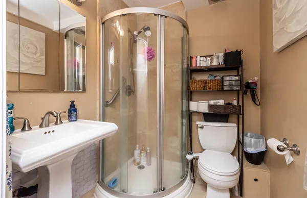 a bathroom with a sink toilet and shower