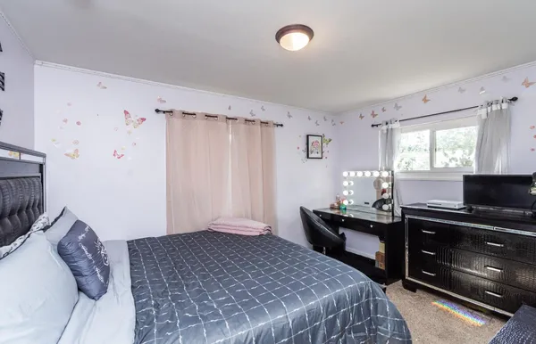 a bedroom with a bed and a desk