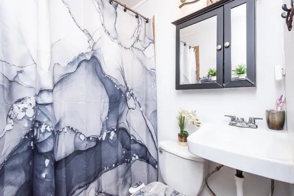 a bathroom with a sink mirror and vanity