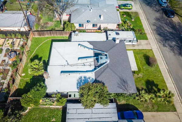 an aerial view of a house with a garden and plants