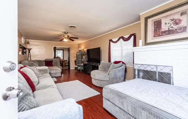 a living room with furniture ceiling fan and a rug