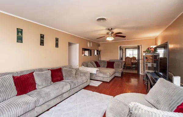 a living room with furniture ceiling fan and a rug
