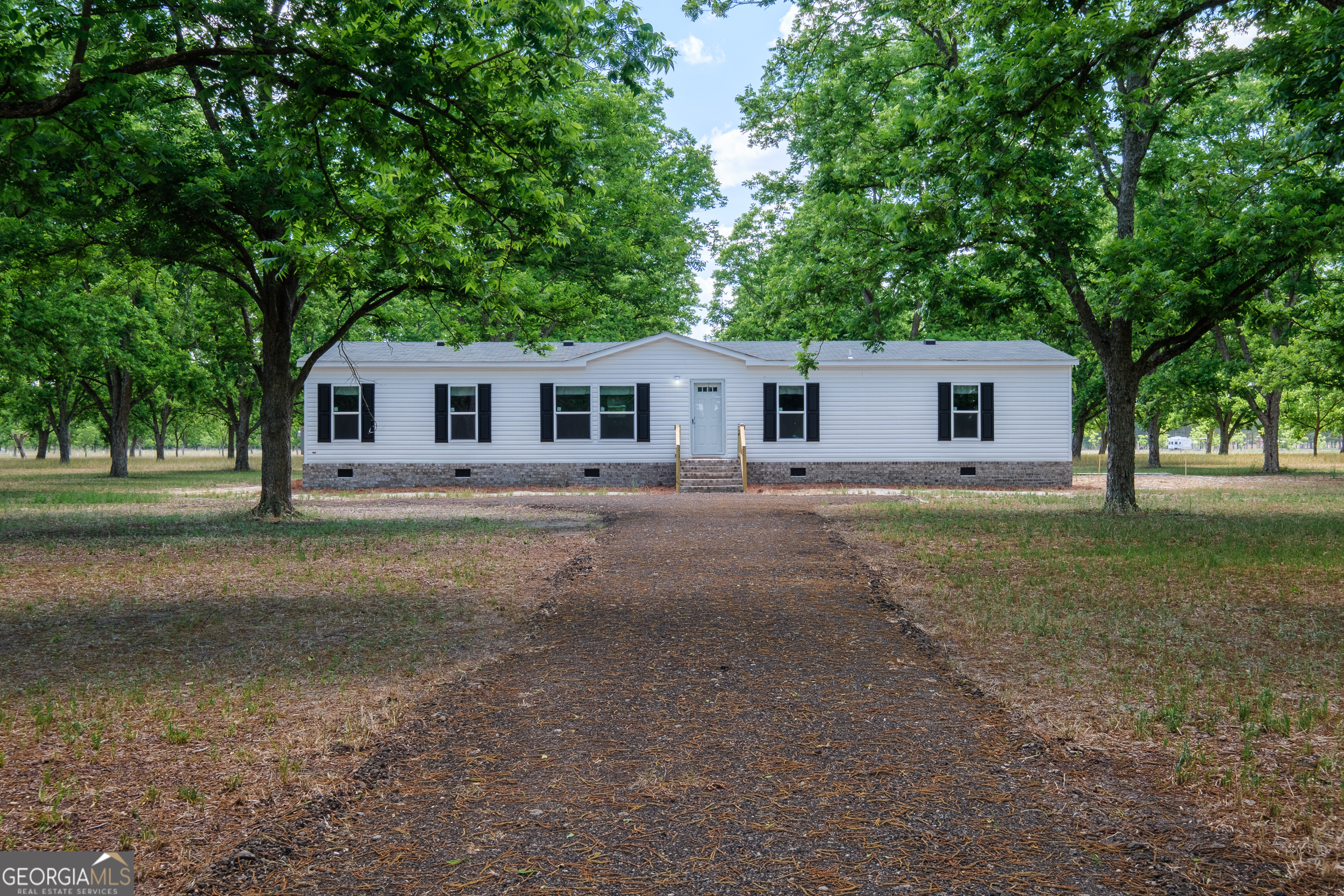2853 Lake Lannell Road Odum, GA 31555 - Photo 1 of 29 a front view of a house with garden