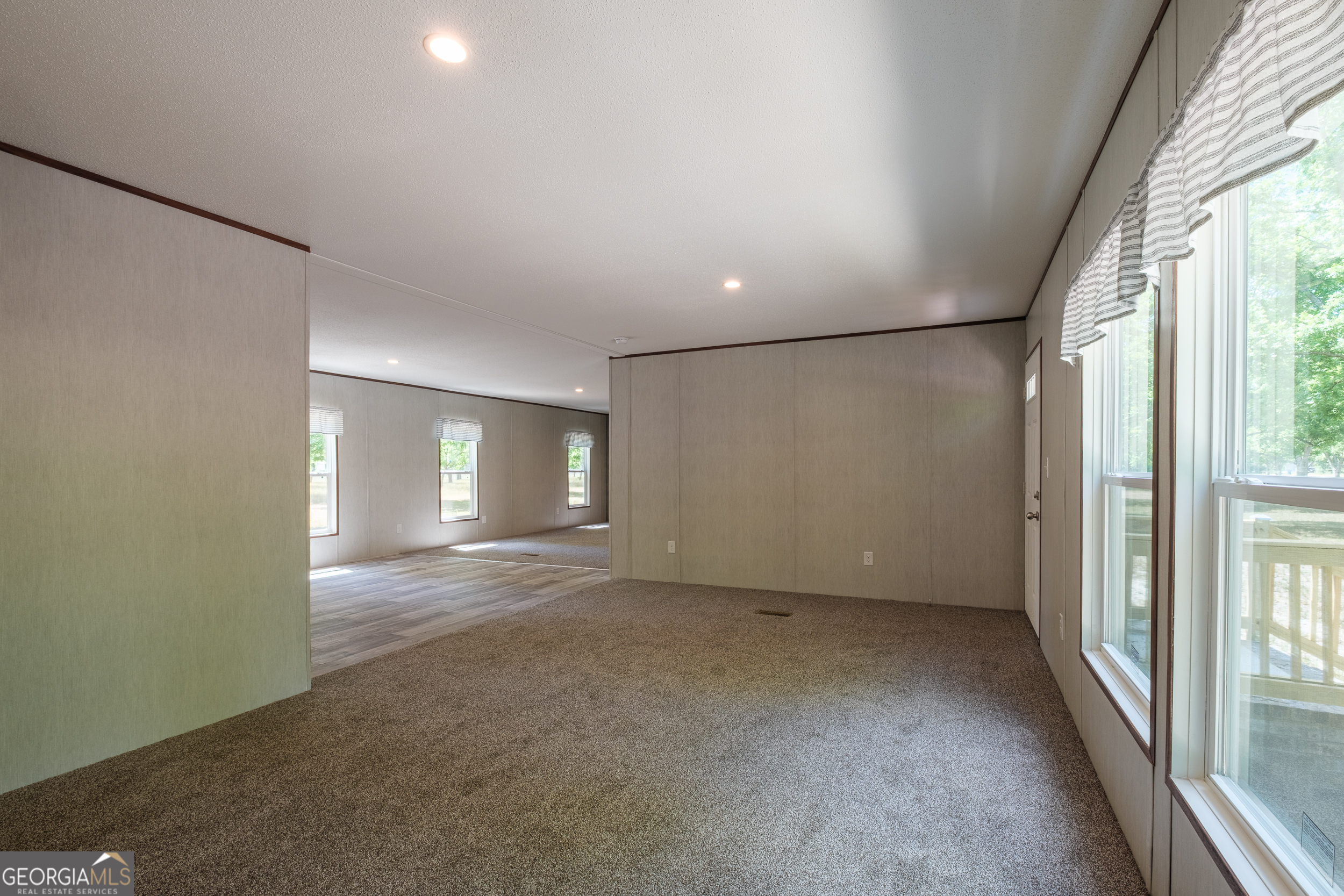 2853 Lake Lannell Road Odum, GA 31555 - Photo 12 of 29 an empty room with windows and entrance