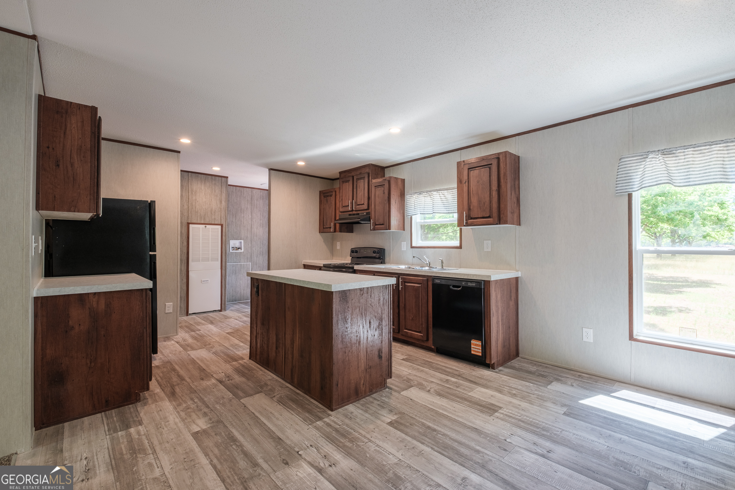 2853 Lake Lannell Road Odum, GA 31555 - Photo 13 of 29 a large kitchen with stainless steel appliances granite countertop a stove a sink and a refrigerator