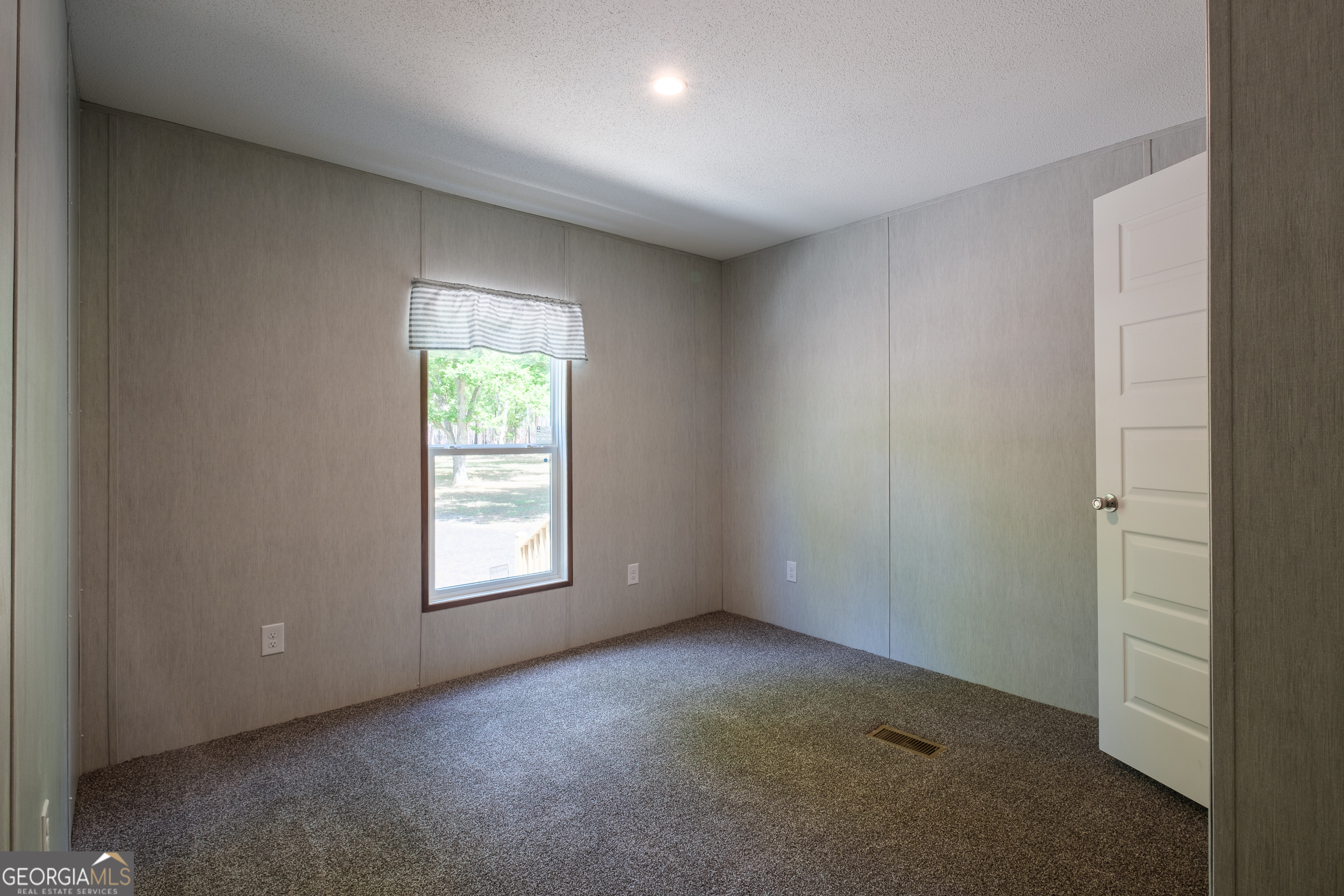 2853 Lake Lannell Road Odum, GA 31555 - Photo 18 of 29 an empty room with windows and closet